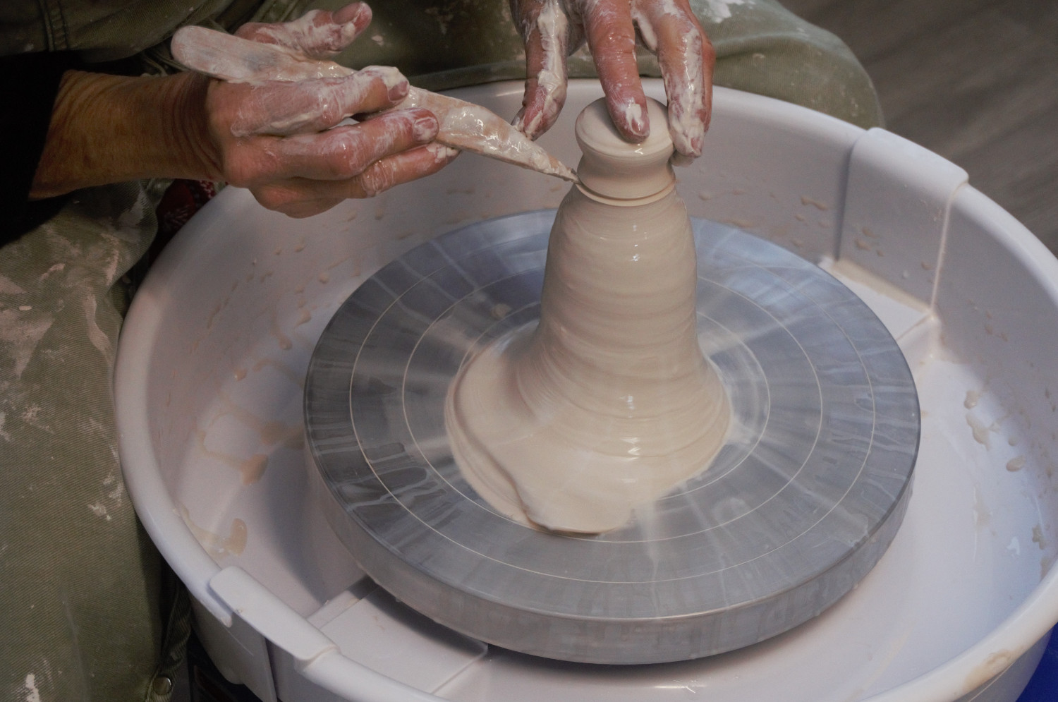 shaping clay with knife