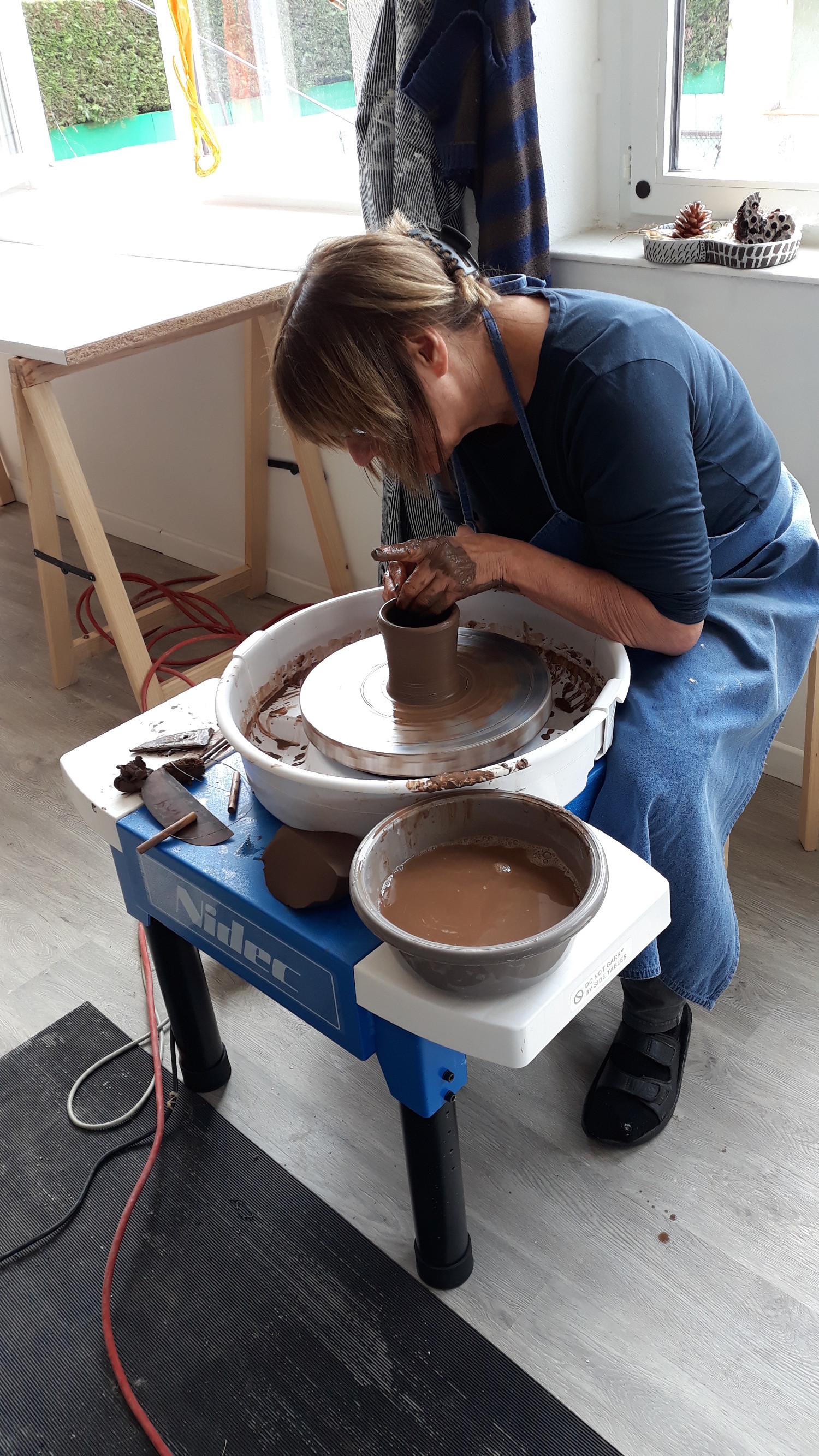 woman using pottery wheel
